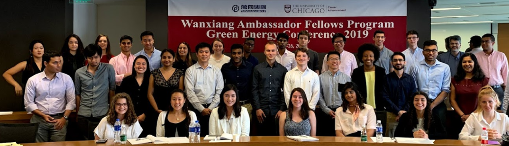 A group of students seated in a classroom in front of a banner reading "Wanxiang Ambassador Fellows Program Green Energy Conference 2019"